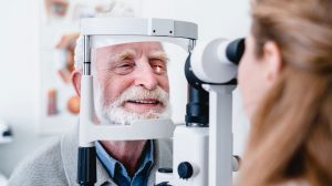 Eye doctor examining senior man